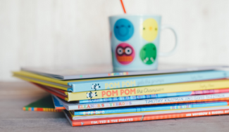 children's books and mug on a desk